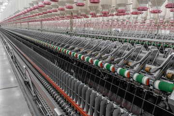 Machinery and equipment in the workshop for the production of thread. interior of industrial textile factory
