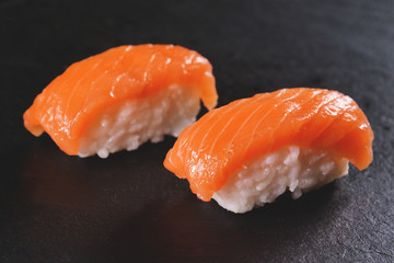  Macro shot of sushi, sashimi, uramaki and nighiri. typical Japanese dish consisting of rice, salmon or tuna,shrimp and fish eggs soaked in soy. Concept: Japanese restaurant, sushi, 