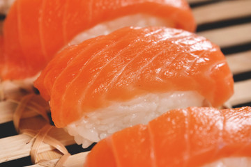  Macro shot of sushi, sashimi, uramaki and nighiri. typical Japanese dish consisting of rice, salmon or tuna,shrimp and fish eggs soaked in soy. Concept: Japanese restaurant, sushi, 