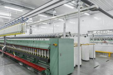 Machinery and equipment in the workshop for the production of thread, general view. interior of industrial textile factory
