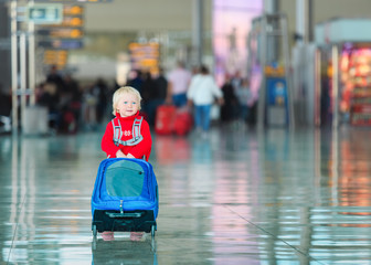 little girl with suitcase travel in the airport