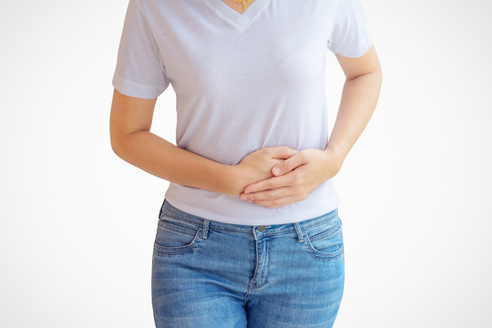 Woman stomachache on white wall background.