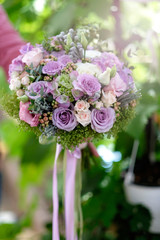 Roses bouquet for bride. Woman hand holding a roses bouquet for bride. Closeup of a handmade roses bouquet for wedding event.