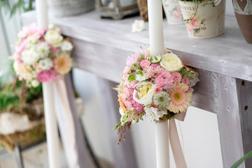 Baptismal candles with floral arrangement. Baptismal white candles with floral arrangement for special events.