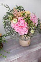 Bouquet of blooming peony. Beautiful bouquet of blooming peony for special events on the table inside flower shop.