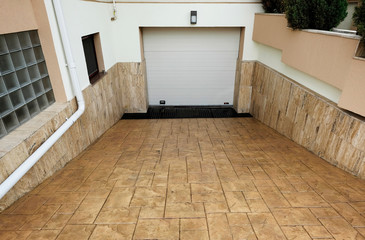 Underground garage. Modern underground garage with automatic door near the house.