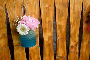 Beautiful flower arrangement design for special events on wooden fence background.