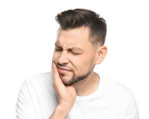 Obraz premium Young man suffering from toothache on white background
