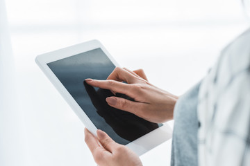 Close-up view of girl using digital tablet with blank screen