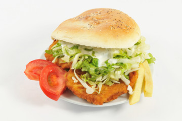 Huge sandwich. Sandwich with chicken, lettuce, tomatoes slices, mayonnaise and fries.