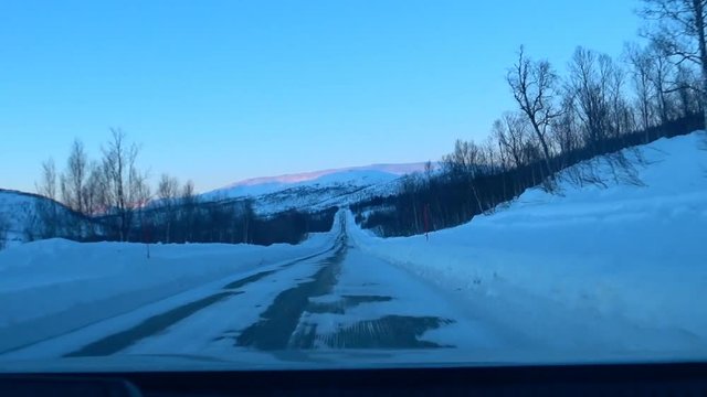 Driving on an icy road on the island Senja in Northern Norway