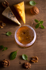Beer and cheese. Beer glass on wooden table. Ale and appetizer snack. overhead, vertical