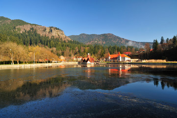 Obraz premium Tusnad resort with Ciucas lake from Romania. A small lake with restaurant near by in Tusnad city (Harghita County, in Transylvania region) from Romania. 