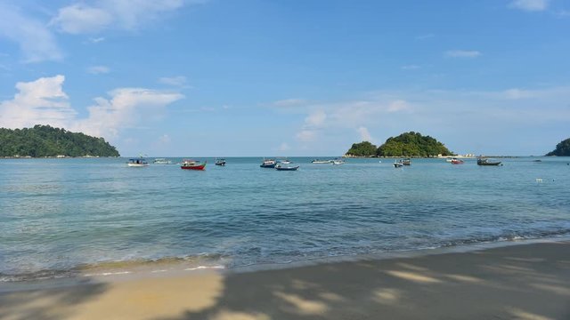 4k time lapse - Scenery of beautiful beach with boats floating and nice blue sky in the morning located in Pangkor Island, perak, malaysia. Ultra high quality h264 4k footage