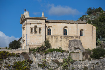Fototapeta na wymiar Side view of the Rock Church of the Rosary (Chiesa Rupestre del Rosario) and convent in Scicli, Sicily