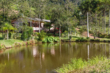Fototapeta na wymiar Farm house with lake, road and forest