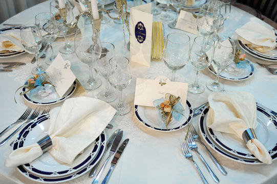 Setting a wedding reception table. Luxury edding reception table with different accessories.
