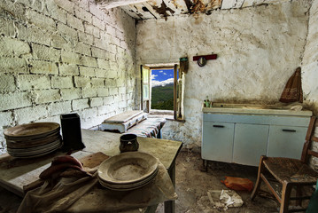 Abandoned house kitchen in the alpine village of Mindino, municipality of Garessio, in Piedmont, Italy.
