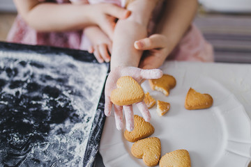 Heart-shaped cookies on the girl's hand