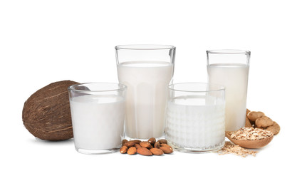 Glasses with different types of milk on white background