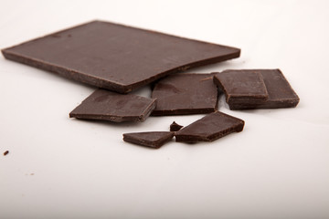 Dark milk chocolate bars stack isolated on a gray background