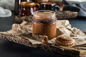 Jar of salted caramel. Traditional recipe of salty caramel of shugar, butter and milk cream.