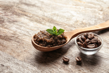 Handmade natural body scrub and coffee beans on wooden background