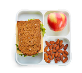 Lunch box with appetizing food on white background, top view