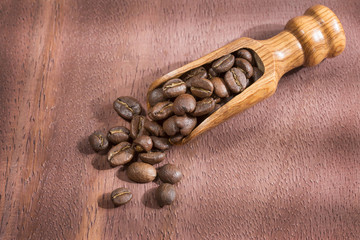 Roasted coffee on the wooden background - Coffee