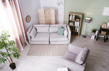 Living room interior with comfortable sofa, view through CCTV camera