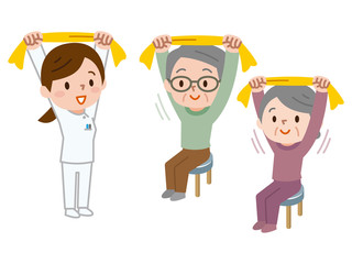 タオルでストレッチをするシニア女性とトレーナー