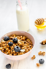Healthy morning with granola breakfast on white kitchen table