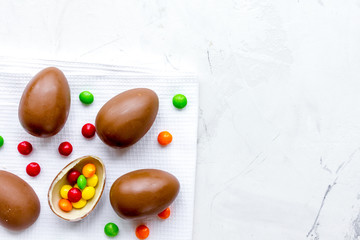 Easter chocolate eggs top view on stone background mock up