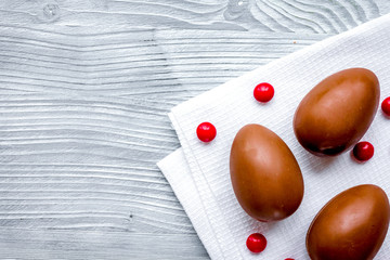 Easter chocolate eggs top view on wooden background mock up