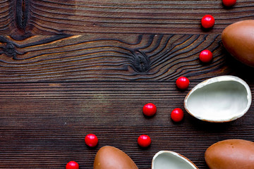 Easter chocolate eggs top view on wooden background mock up