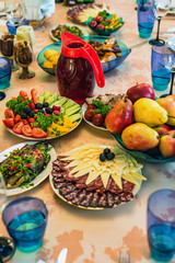 Festive table with vegetables, fruit and snacks