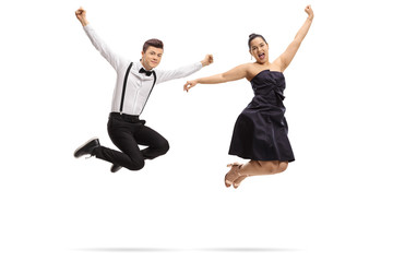 Fototapeta na wymiar Formally dressed teenagers jumping and gesturing happiness