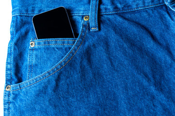 Black modern smartphone in the pocket of old vintage indigo stonewashed jeans. Concept of daily...