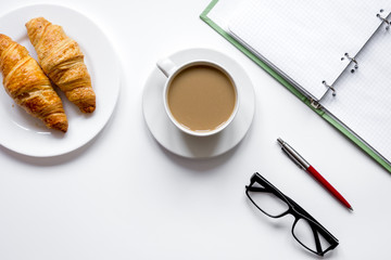 Business lunch with croissant on white table top view