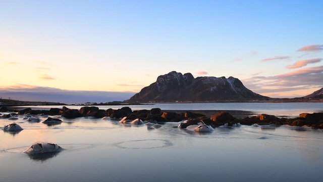 Winter light over a frozen fjord and mountains at Vesteralen in Northern Norway