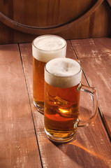 Fresh and cold beer in glass. Tasty beer concept on wooden background.