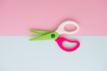 Minimal flat lay concept of colourful scissors on the colorful background with copy space