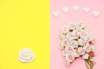 Pink and white roses, heart shape stones and gift wrapped on flat lay paper, happy mothers day