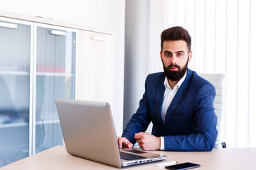 Young Businessman Working On Laptop At Office