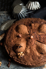 Chocolate cake with pears stewed in red wine, hazelnuts, walnuts. Traditional dessert. Top view.