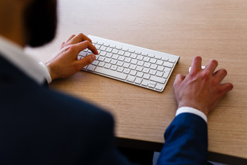 Young Businessman Typing On Keyboard