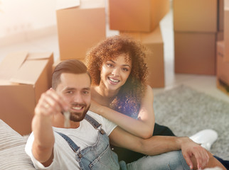 Young couple with a key to a new apartment.