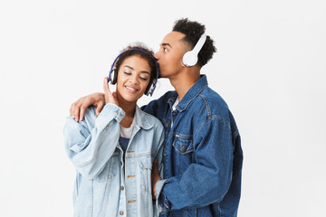 Happy lovely african couple in denim shirts posing together