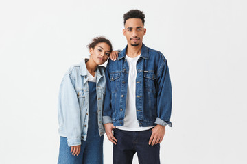 Young african couple in denim shirts posing together