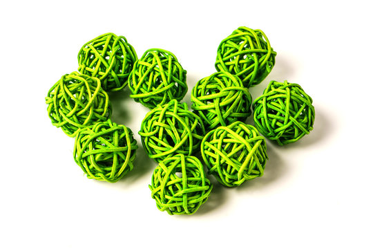 Green rattan light balls on white background. Creative decoration concept for Christmas celebration and Holiday.